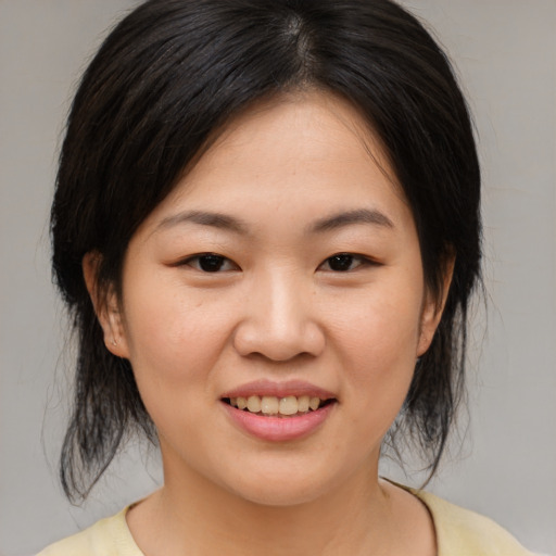 Joyful asian young-adult female with medium  brown hair and brown eyes