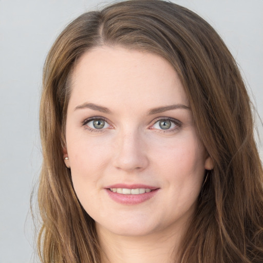 Joyful white young-adult female with long  brown hair and grey eyes