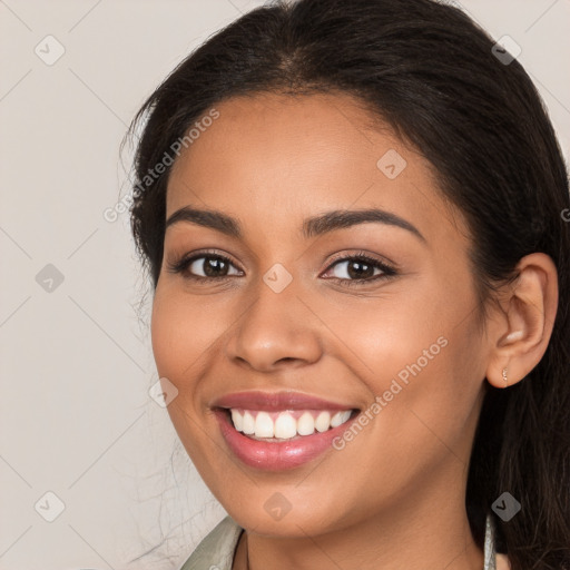 Joyful white young-adult female with long  brown hair and brown eyes