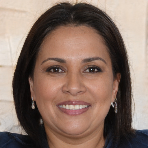 Joyful white adult female with long  brown hair and brown eyes