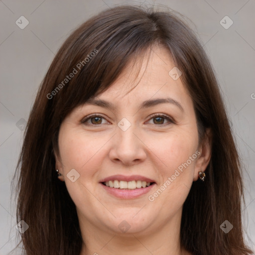 Joyful white adult female with long  brown hair and brown eyes