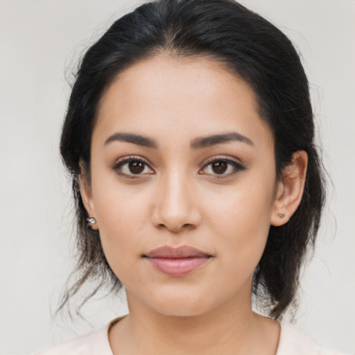 Joyful latino young-adult female with medium  brown hair and brown eyes