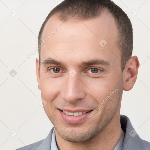 Joyful white young-adult male with short  brown hair and brown eyes