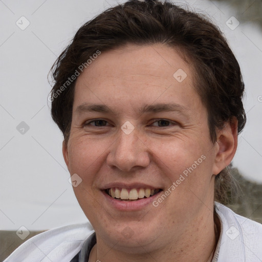 Joyful white adult male with short  brown hair and grey eyes