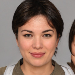 Joyful white young-adult female with medium  brown hair and brown eyes