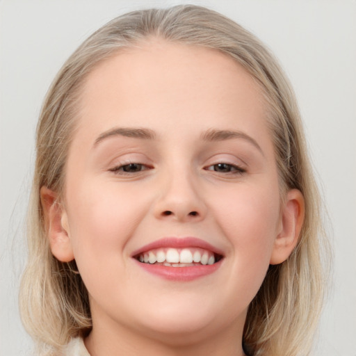 Joyful white young-adult female with medium  brown hair and blue eyes