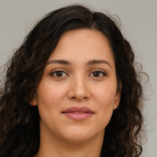 Joyful white young-adult female with long  brown hair and brown eyes