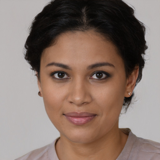 Joyful latino young-adult female with medium  brown hair and brown eyes
