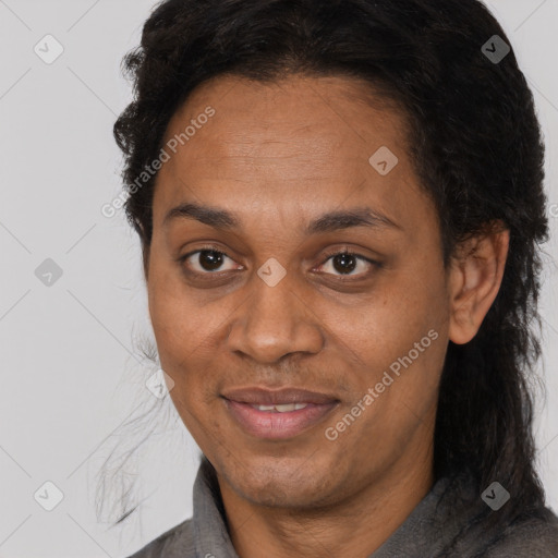 Joyful black adult female with long  brown hair and brown eyes