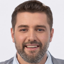 Joyful white adult male with short  brown hair and brown eyes