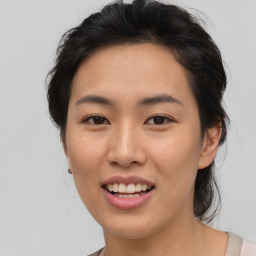 Joyful asian young-adult female with medium  brown hair and brown eyes