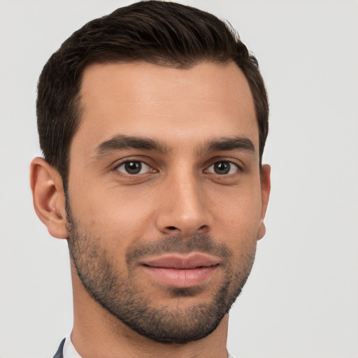 Joyful white young-adult male with short  brown hair and brown eyes