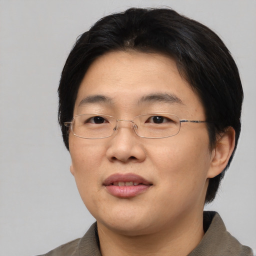 Joyful asian adult female with short  black hair and brown eyes