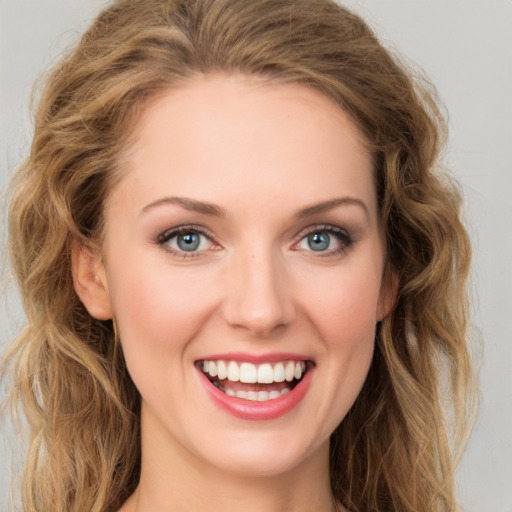 Joyful white young-adult female with long  brown hair and green eyes