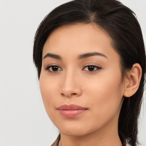 Joyful asian young-adult female with long  brown hair and brown eyes