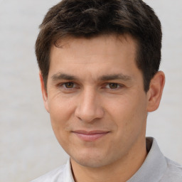 Joyful white adult male with short  brown hair and brown eyes