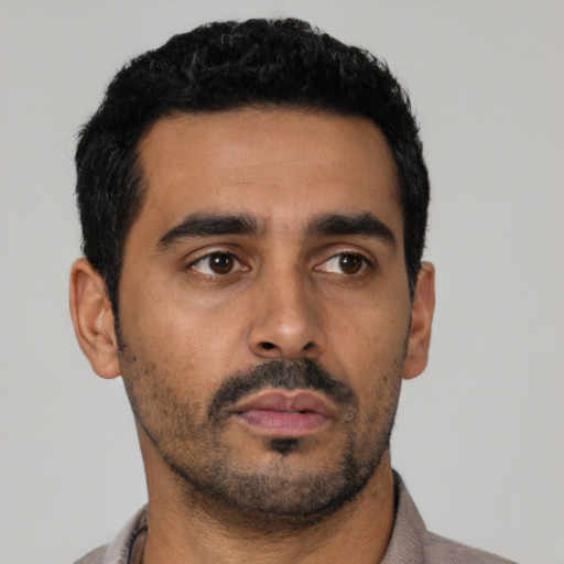 Neutral latino young-adult male with short  black hair and brown eyes