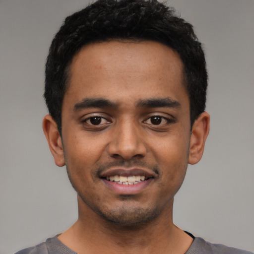 Joyful latino young-adult male with short  black hair and brown eyes