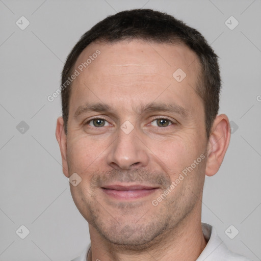 Joyful white adult male with short  brown hair and brown eyes