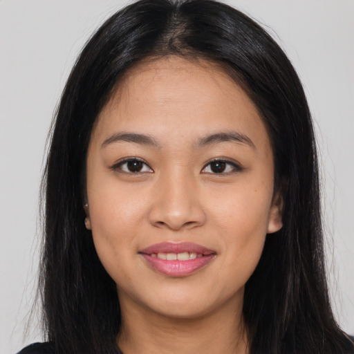 Joyful asian young-adult female with long  black hair and brown eyes