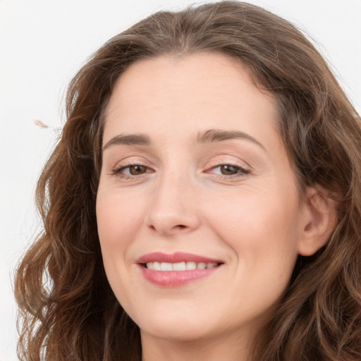 Joyful white young-adult female with long  brown hair and green eyes