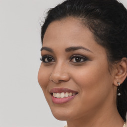 Joyful latino young-adult female with long  brown hair and brown eyes