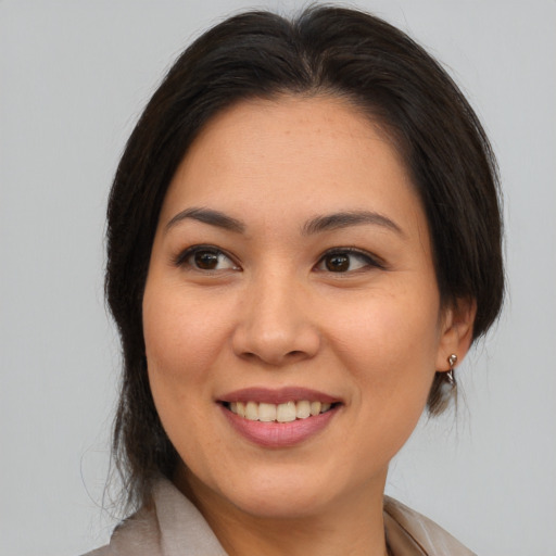 Joyful white young-adult female with medium  brown hair and brown eyes