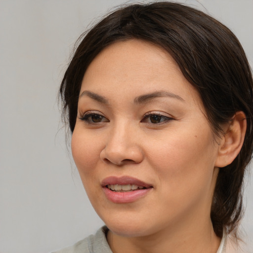 Joyful asian young-adult female with medium  brown hair and brown eyes