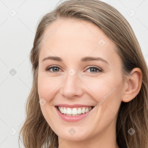 Joyful white young-adult female with long  brown hair and grey eyes