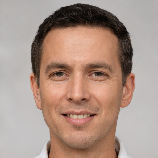 Joyful white adult male with short  brown hair and brown eyes