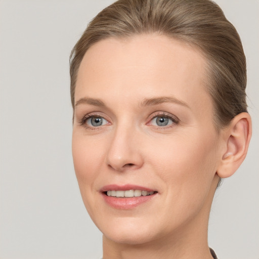 Joyful white adult female with short  brown hair and grey eyes