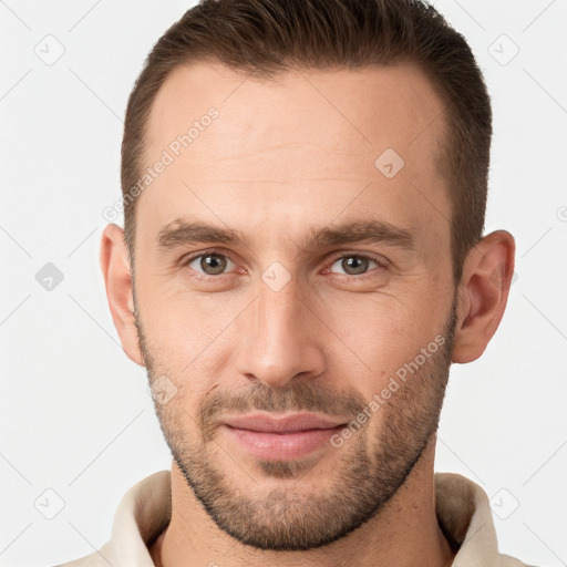 Joyful white young-adult male with short  brown hair and brown eyes