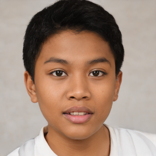 Joyful latino child male with short  black hair and brown eyes