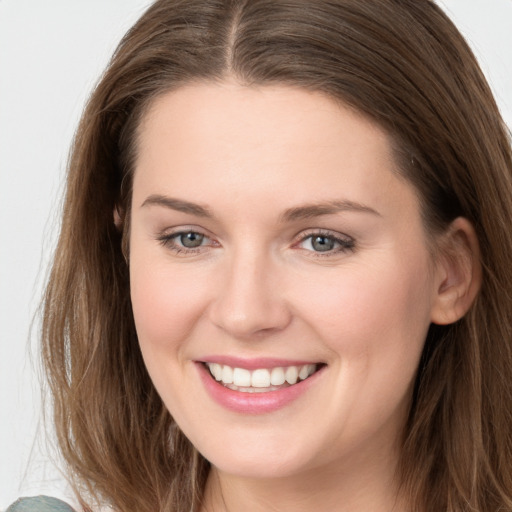 Joyful white young-adult female with long  brown hair and grey eyes