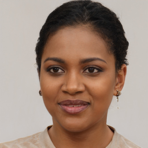 Joyful black young-adult female with short  brown hair and brown eyes