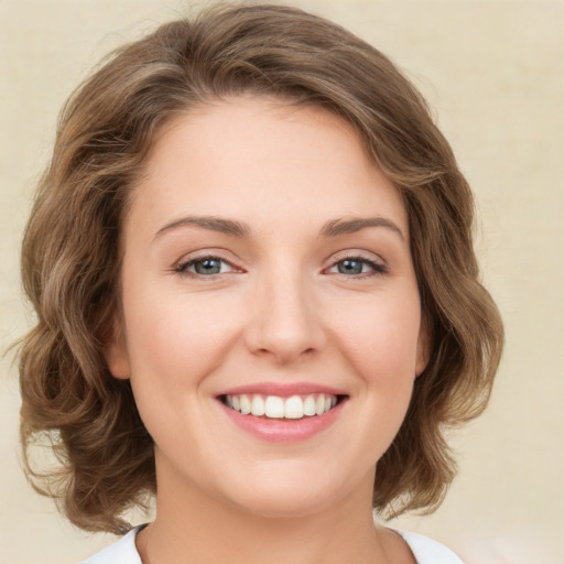 Joyful white young-adult female with medium  brown hair and green eyes