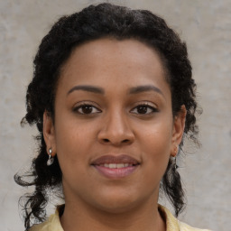 Joyful black young-adult female with medium  brown hair and brown eyes