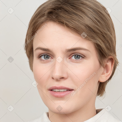 Joyful white young-adult female with medium  brown hair and grey eyes