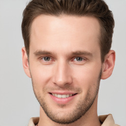 Joyful white young-adult male with short  brown hair and grey eyes