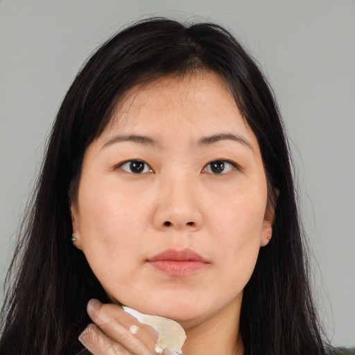 Neutral asian young-adult female with long  brown hair and brown eyes