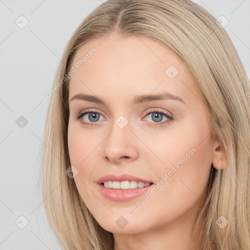 Joyful white young-adult female with long  brown hair and blue eyes