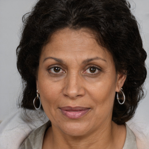 Joyful black adult female with medium  brown hair and brown eyes