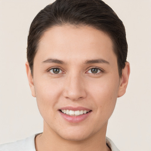 Joyful white young-adult female with short  brown hair and brown eyes