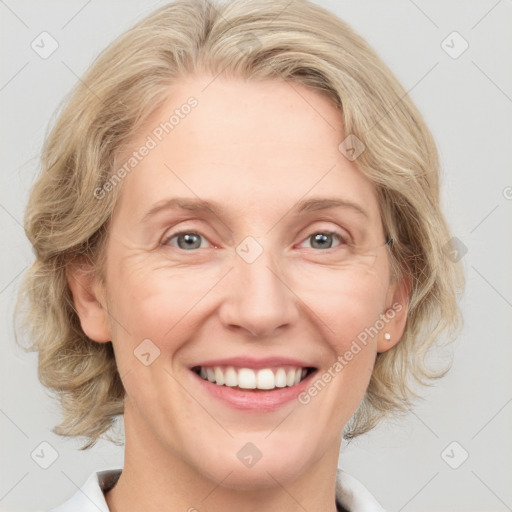 Joyful white adult female with medium  brown hair and blue eyes