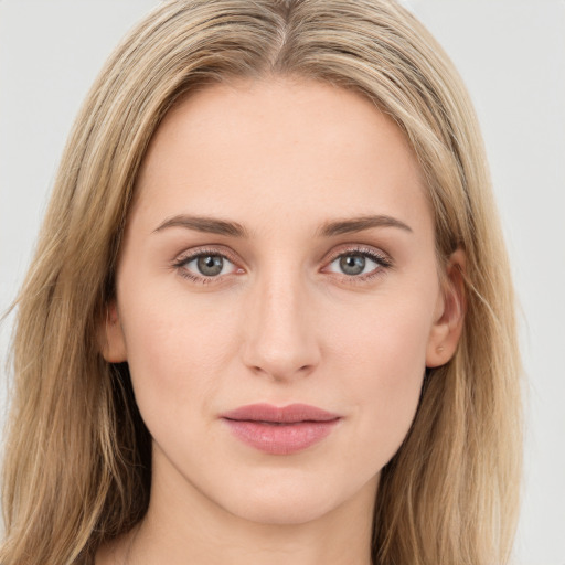 Joyful white young-adult female with long  brown hair and green eyes