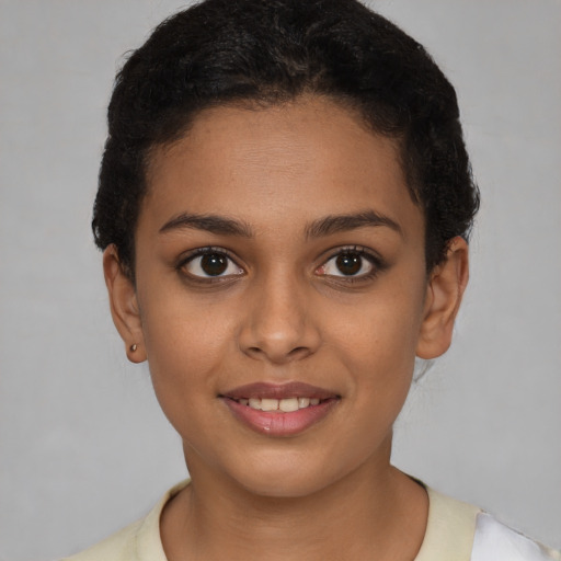 Joyful latino young-adult female with short  brown hair and brown eyes