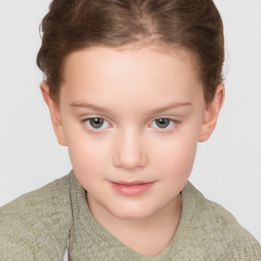 Joyful white child female with short  brown hair and brown eyes