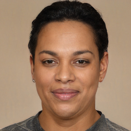 Joyful latino adult female with short  black hair and brown eyes