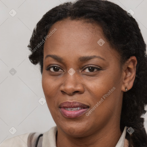 Joyful black adult female with short  brown hair and brown eyes