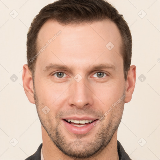 Joyful white young-adult male with short  brown hair and grey eyes